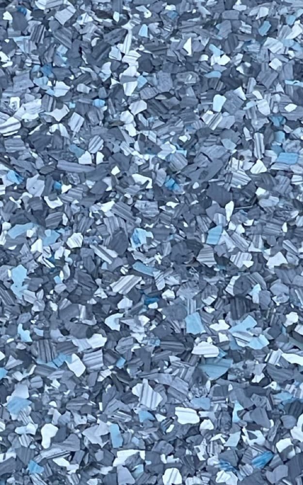 Finished decorative flake floor coating close-up with Kiwi Coatings branding