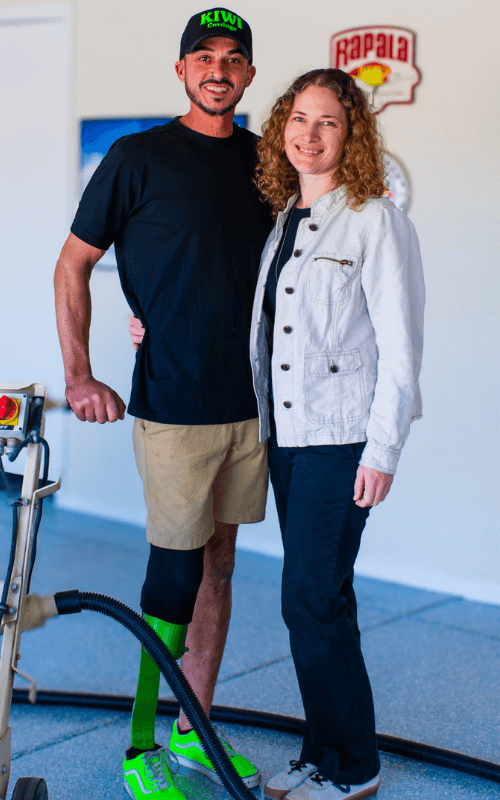 Randy and a Kiwi Coatings team member standing beside floor coating equipment