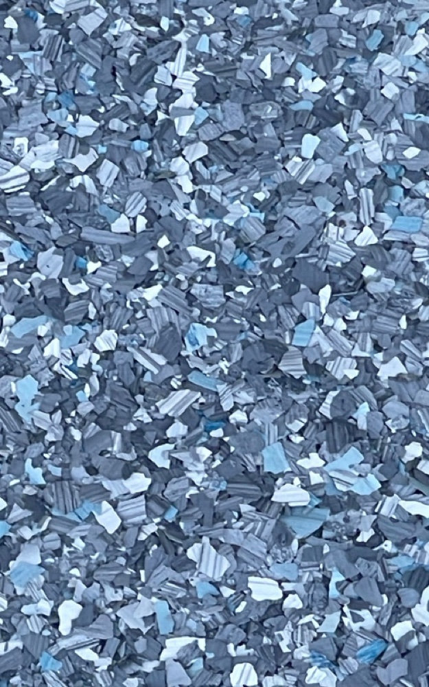 Finished decorative flake floor coating close-up with Kiwi Coatings branding