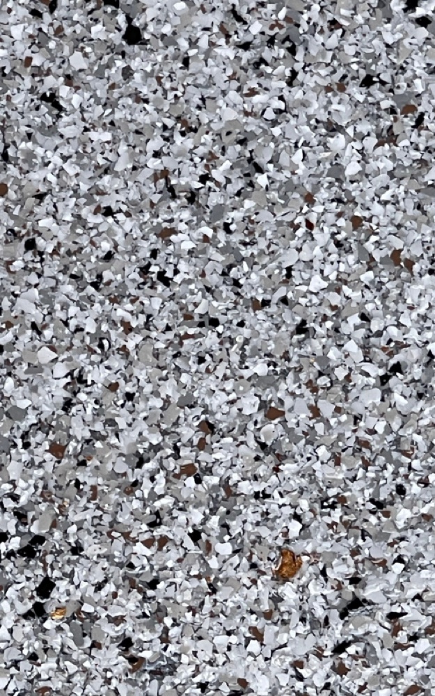 Close-up of a durable gray and white quartz broadcast floor coating texture